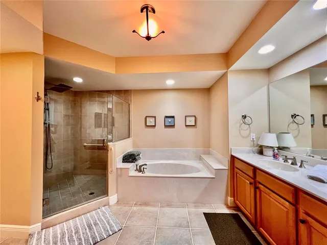 a bathroom with a sink a toilet a mirror and shower curtain