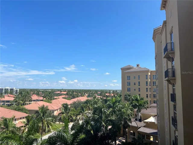 a front view of a house with a garden and lake view