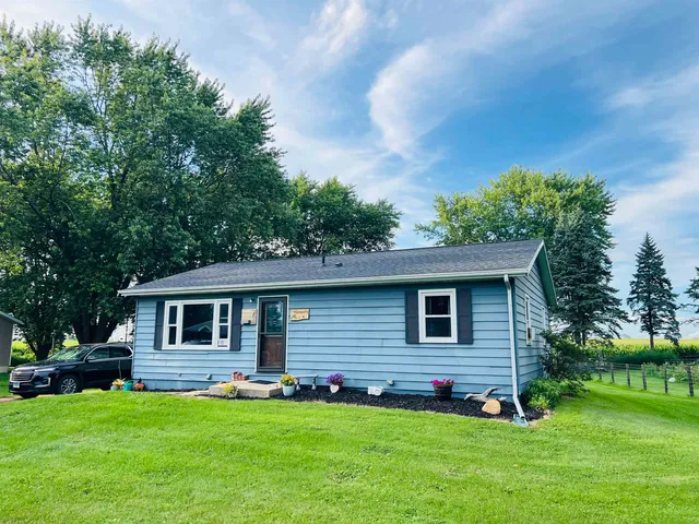 a front view of house with a garden