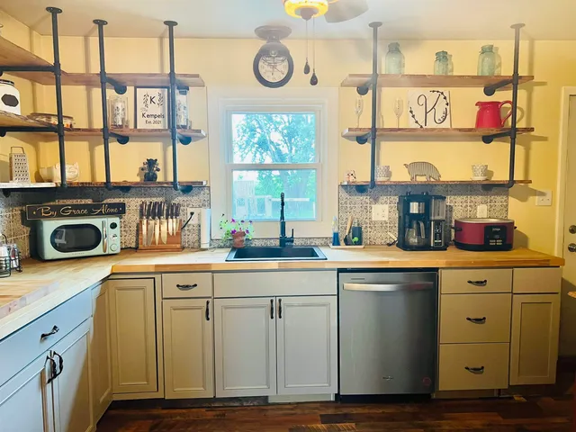 a kitchen with lots of counter top space and windows