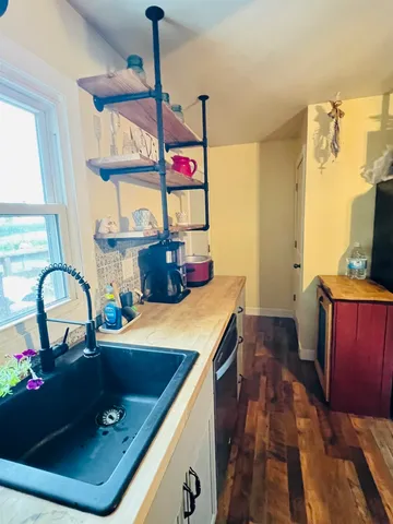 a kitchen with a sink appliances and cabinets