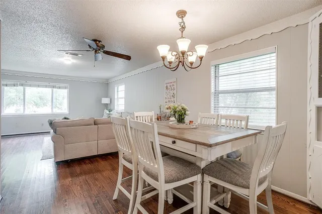 a view of a dining room with furniture wooden floor and chandelier