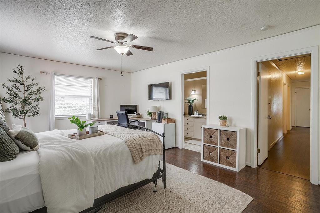 3217 Lubbock Avenue Fort Worth, TX 76109 - Photo 17 of 38 a bedroom with a bed and a chandelier