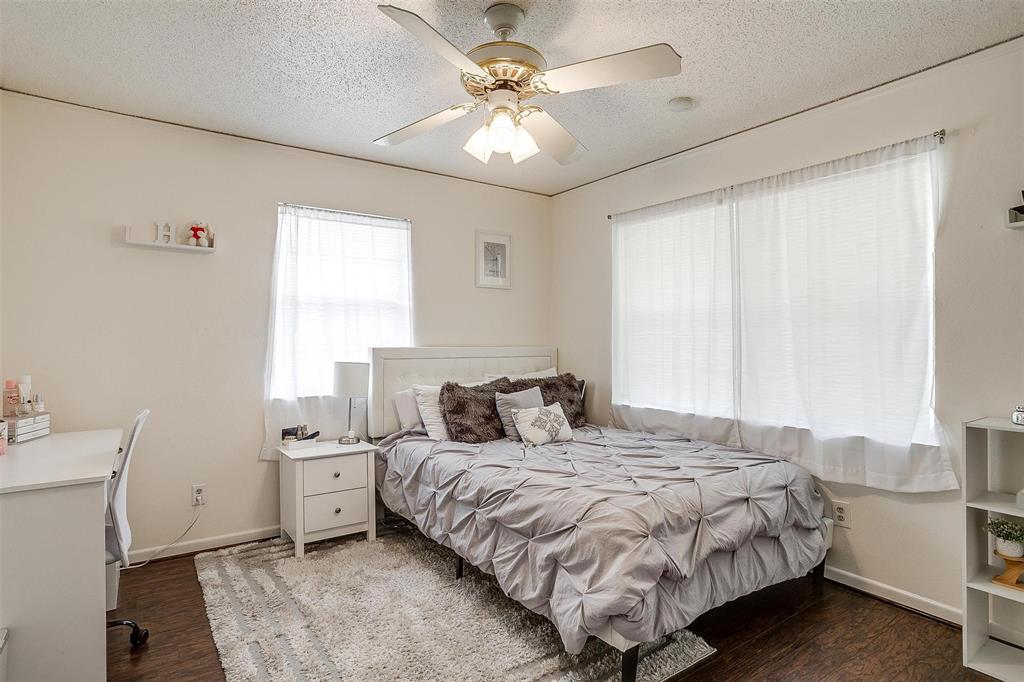 3217 Lubbock Avenue Fort Worth, TX 76109 - Photo 22 of 38 a bedroom with a bed a chandelier and a window