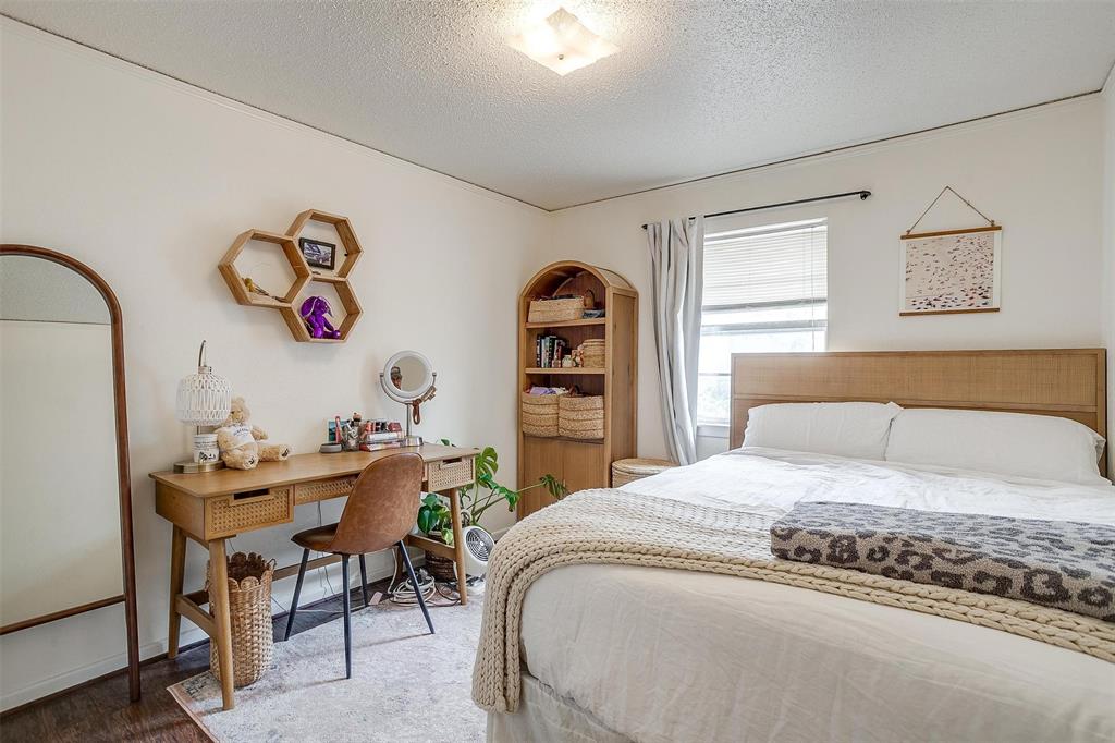 3217 Lubbock Avenue Fort Worth, TX 76109 - Photo 26 of 38 a bedroom with a bed and a table in it