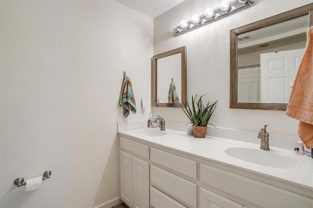 3217 Lubbock Avenue Fort Worth, TX 76109 - Photo 28 of 38 a bathroom with a double vanity sink and a mirror