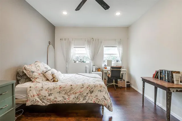a bedroom with a bed and a dresser in it