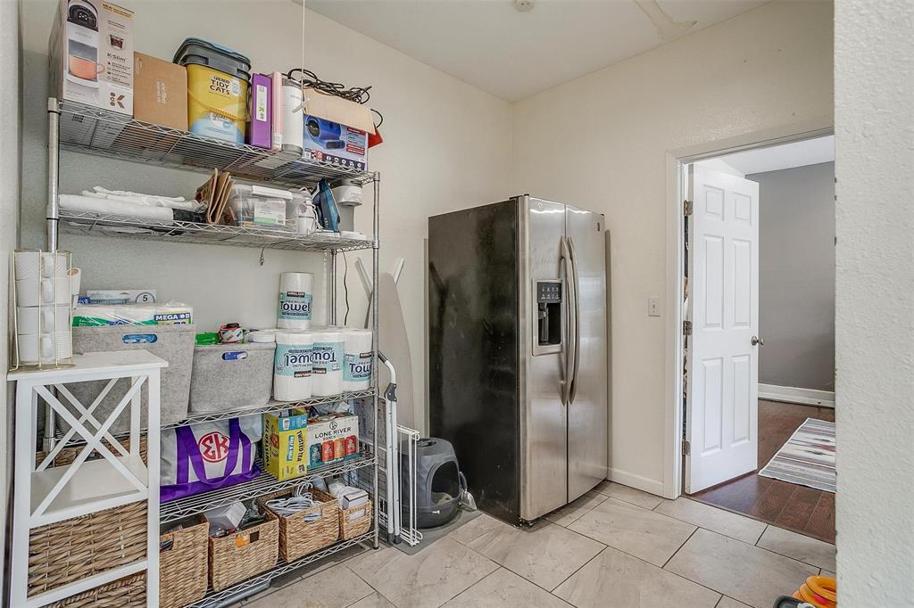 3217 Lubbock Avenue Fort Worth, TX 76109 - Photo 35 of 38 a kitchen with stainless steel appliances and a refrigerator