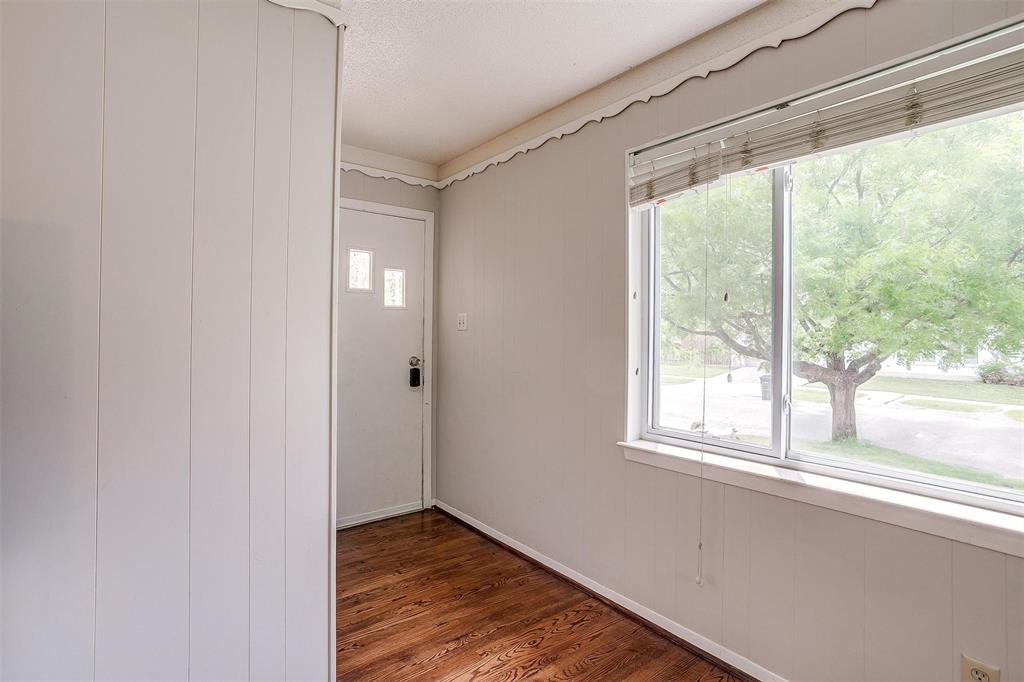 3217 Lubbock Avenue Fort Worth, TX 76109 - Photo 5 of 38 a view of an empty room with wooden floor and a window