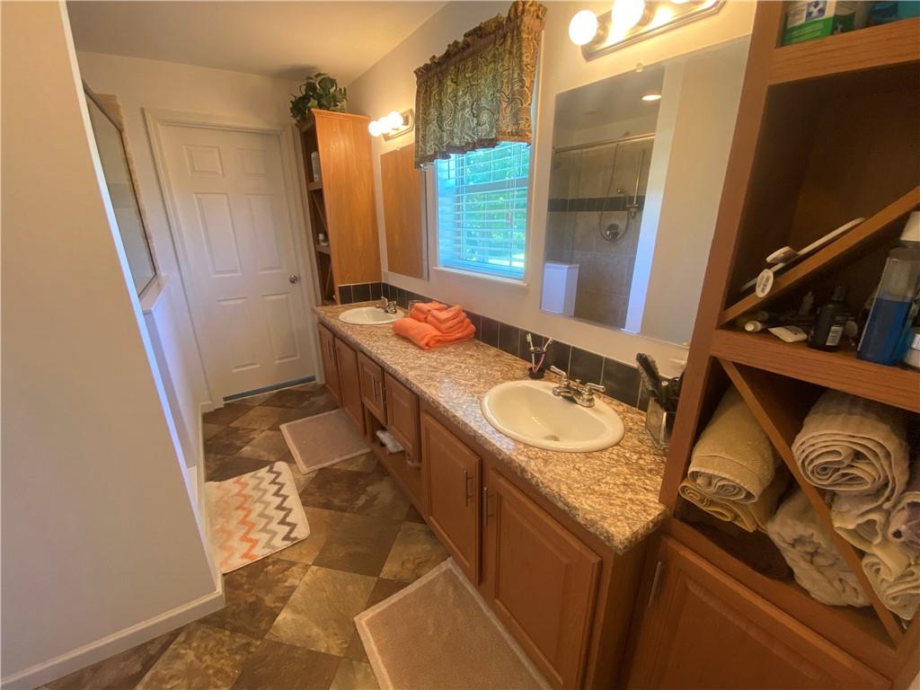 232 Center School Road Jefferson, PA 15344 - Photo 13 of 22 a bathroom with a granite countertop sink and a mirror