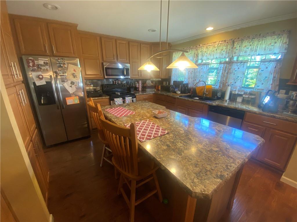 232 Center School Road Jefferson, PA 15344 - Photo 5 of 22 a kitchen with stainless steel appliances granite countertop a sink a stove and a refrigerator