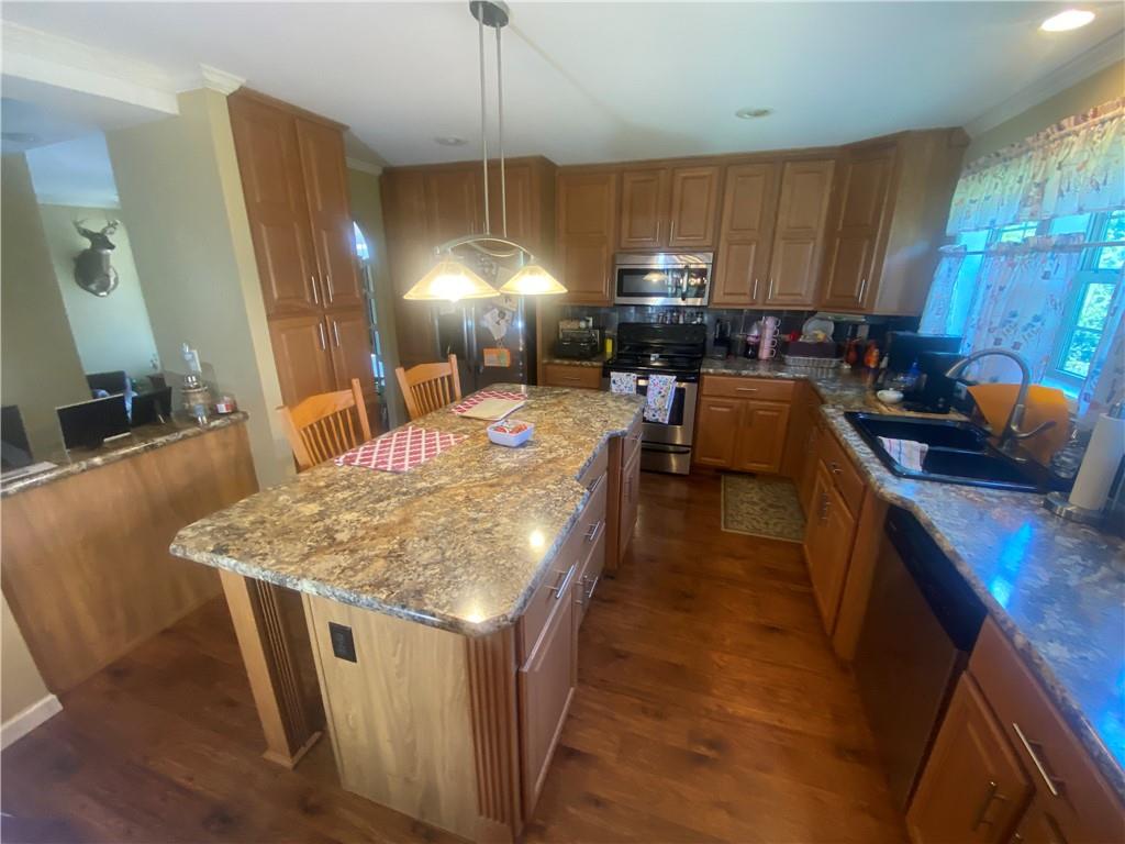 232 Center School Road Jefferson, PA 15344 - Photo 6 of 22 a kitchen with kitchen island granite countertop a sink stove and refrigerator