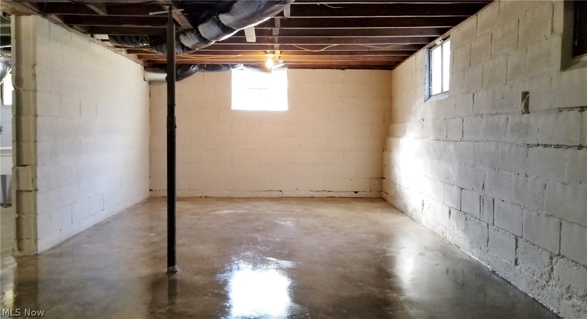6527 North Ridge Road East Geneva, OH 44041 - Photo 35 of 35 Basement: Work Area/Storage Area: 2021 Improvements: New Concrete Floor Poured (6/21), New Glass Block Window w Vent, Fresh Block Seal Paint: Clean/Dry Basement