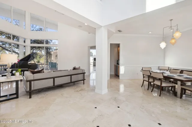 a view of a dining room with furniture and chandelier