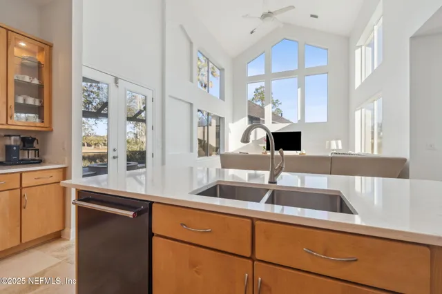 a living room with a large window and a rug