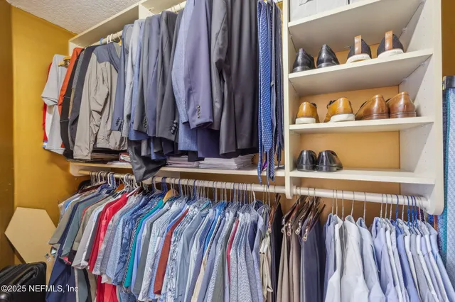 a view of a street with a building and a big yard