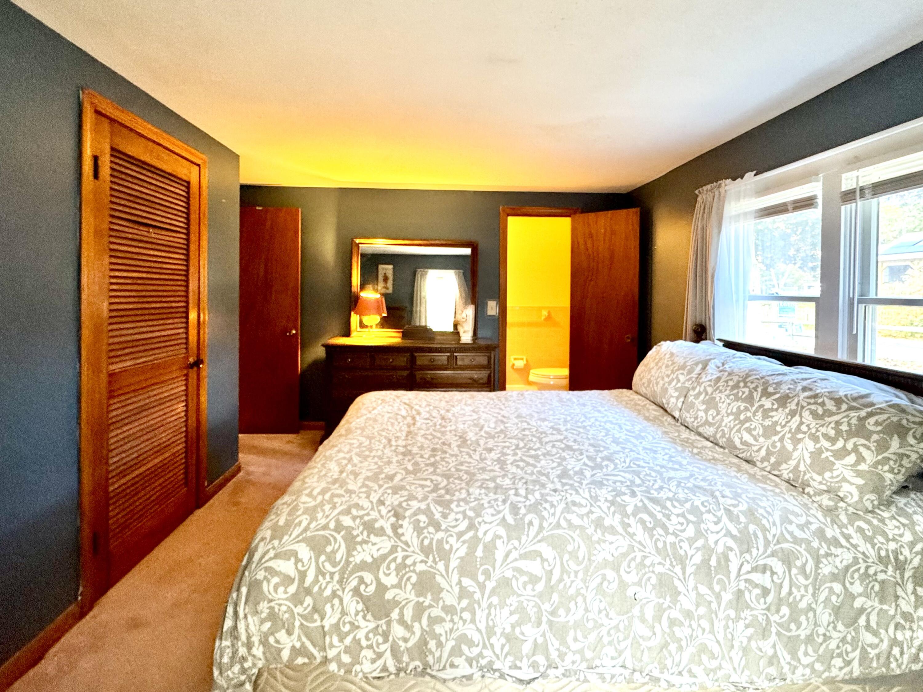 7 Delta Street Hyannis, MA 02601 - Photo 18 of 29 a bedroom with a bed and a dresser next to a window