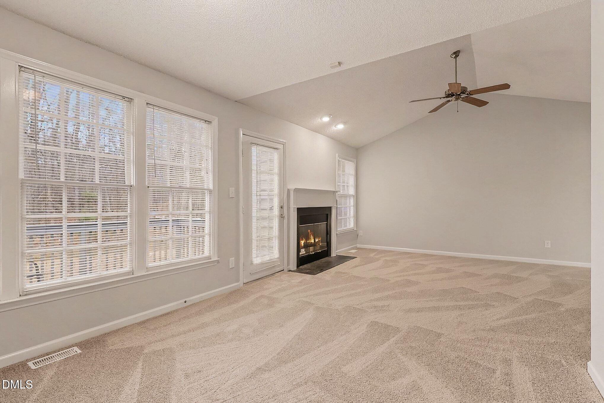7 Neptune Court Durham, NC 27712 - Photo 13 of 39 a view of an empty room with a fireplace and a window
