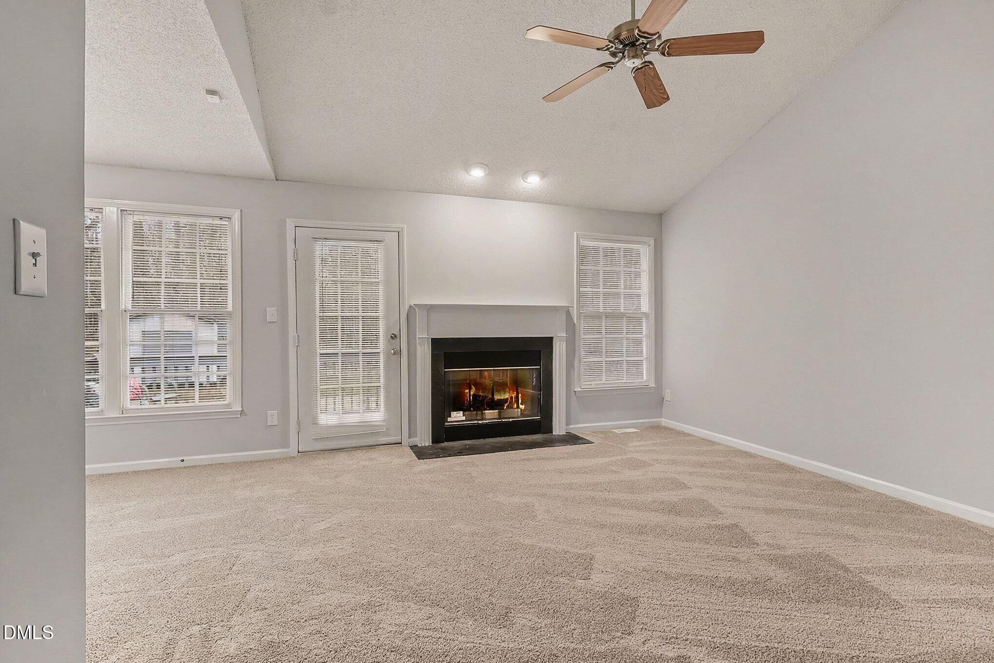 7 Neptune Court Durham, NC 27712 - Photo 17 of 39 an empty room with windows and fireplace