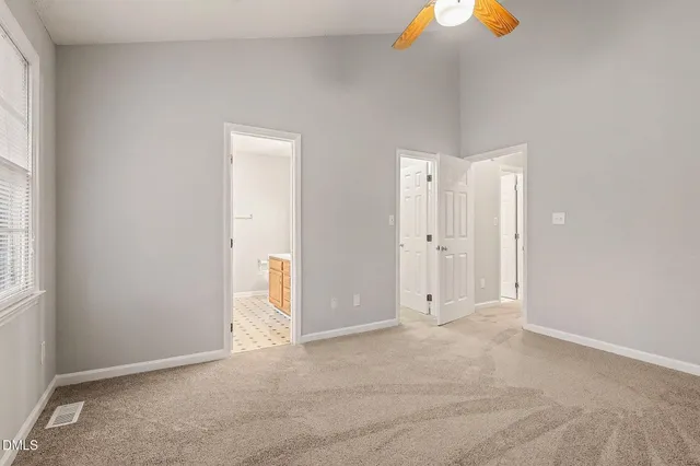 an empty room with windows and closet