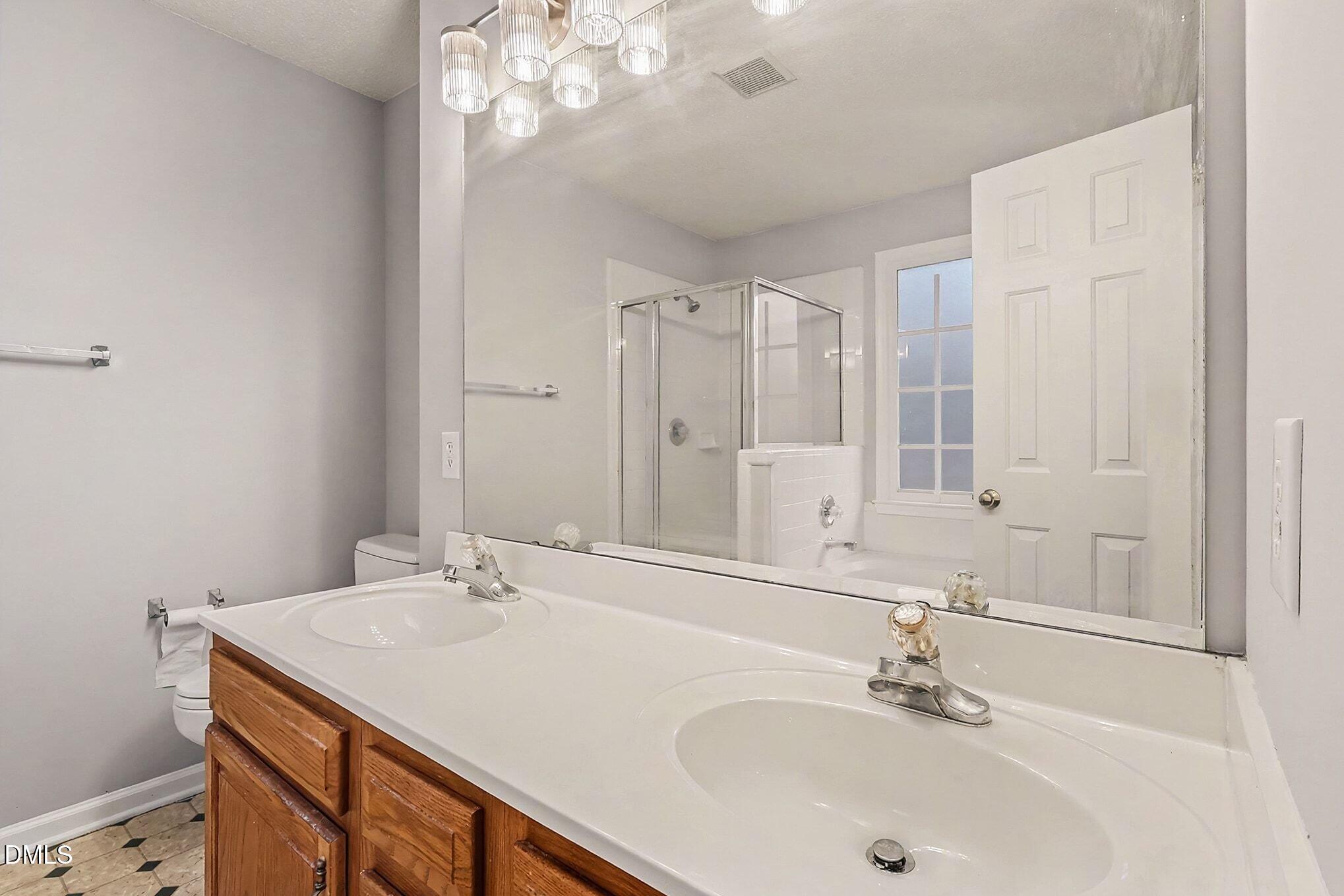 7 Neptune Court Durham, NC 27712 - Photo 21 of 39 a bathroom with a sink and a mirror