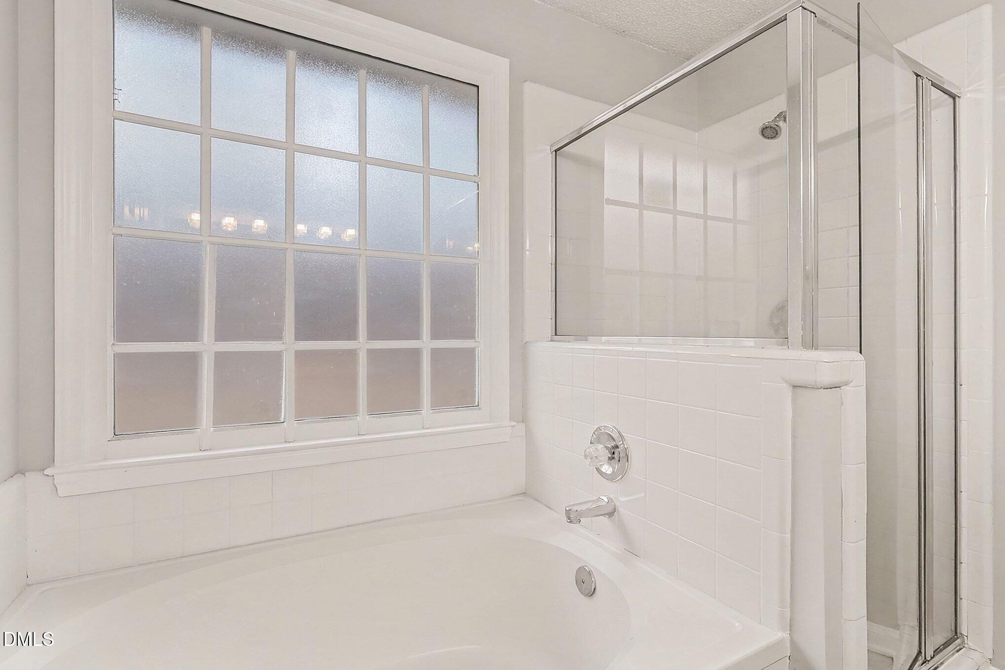 7 Neptune Court Durham, NC 27712 - Photo 22 of 39 a bathroom with a bathtub and a shower