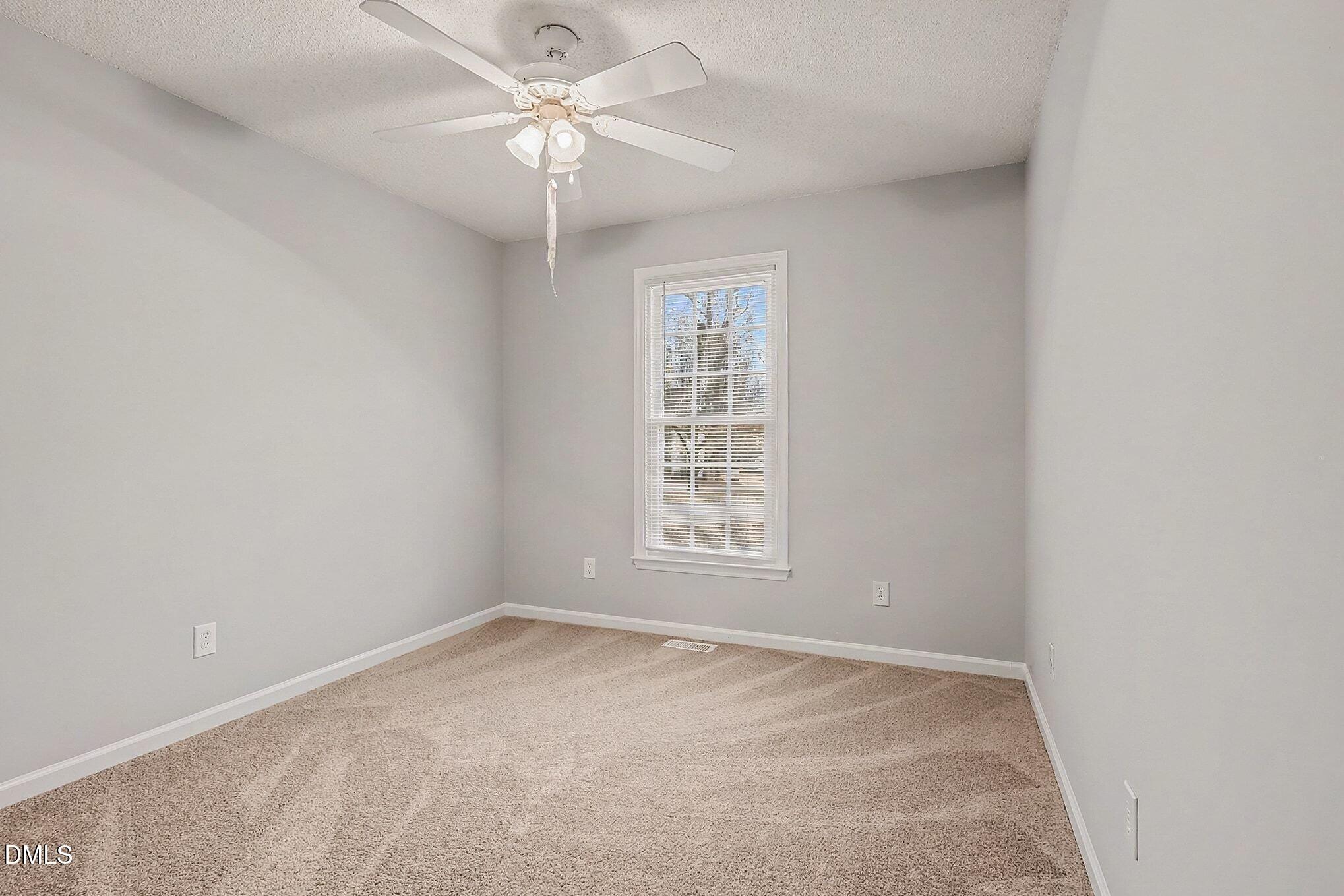 7 Neptune Court Durham, NC 27712 - Photo 24 of 39 an empty room with a window and a fan