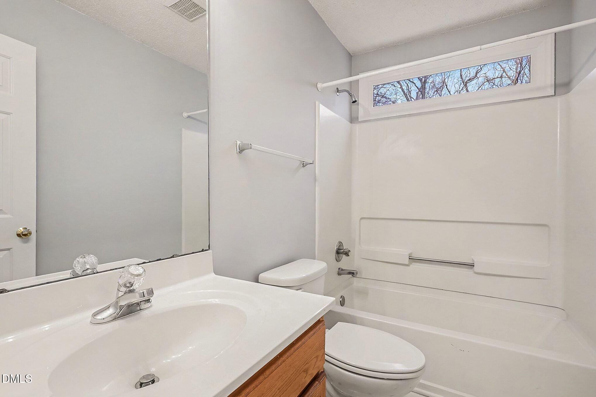7 Neptune Court Durham, NC 27712 - Photo 28 of 39 a bathroom with a sink a toilet and shower