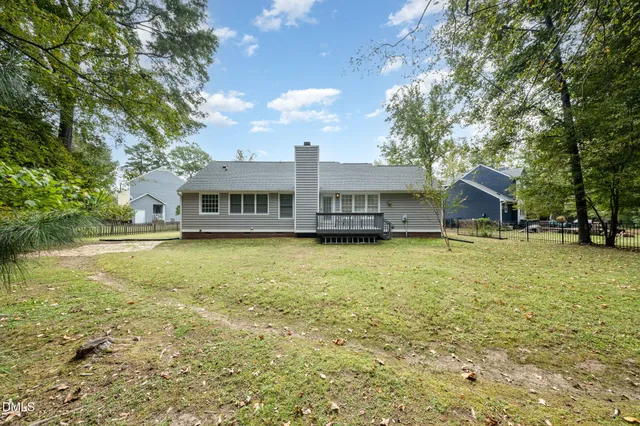a view of a patio with chairs and table of the backyard