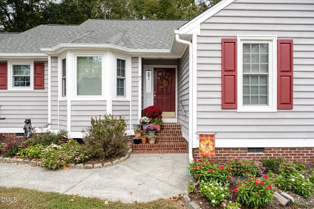 a view of a house with potted plants