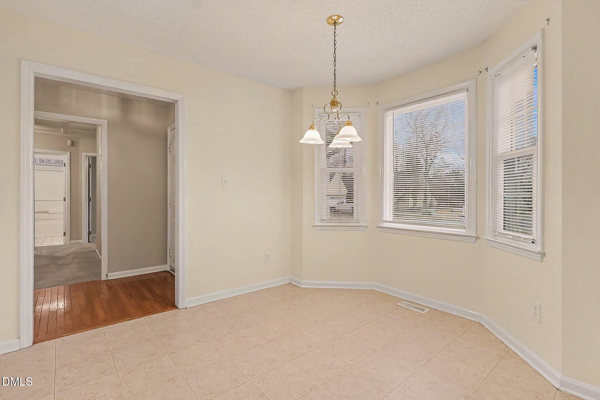 7 Neptune Court Durham, NC 27712 - Photo 9 of 39 a view of empty room with windows and chandelier