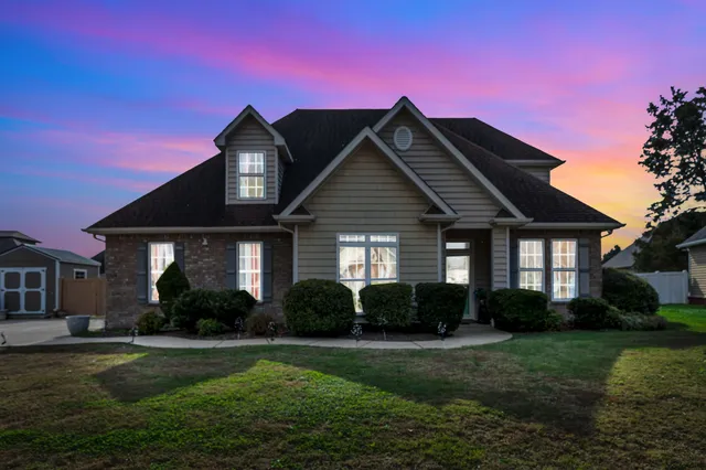a front view of a house with a yard
