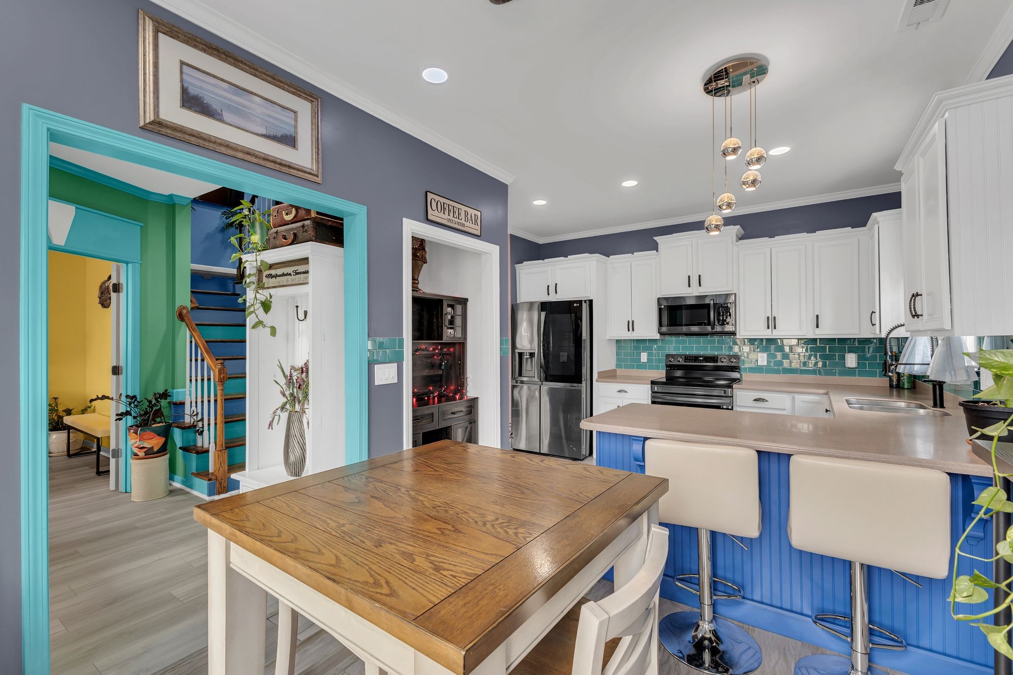 1726 Splash Place Murfreesboro, TN 37130 - Photo 13 of 42 a kitchen with stainless steel appliances granite countertop a refrigerator a stove top oven a dining table and chairs with wooden floor
