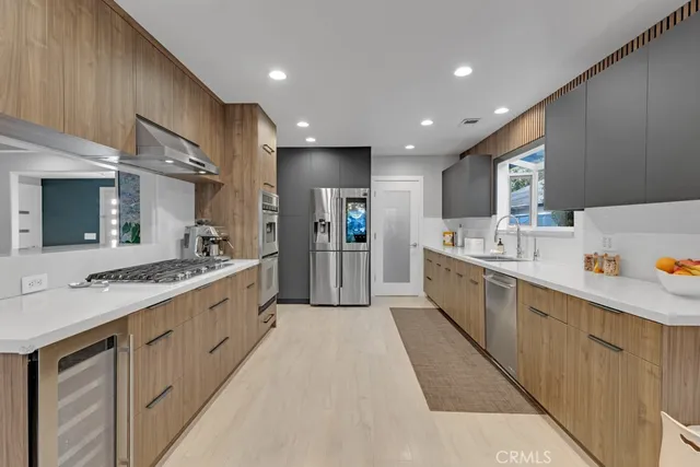 a large kitchen with stainless steel appliances lots of counter top space