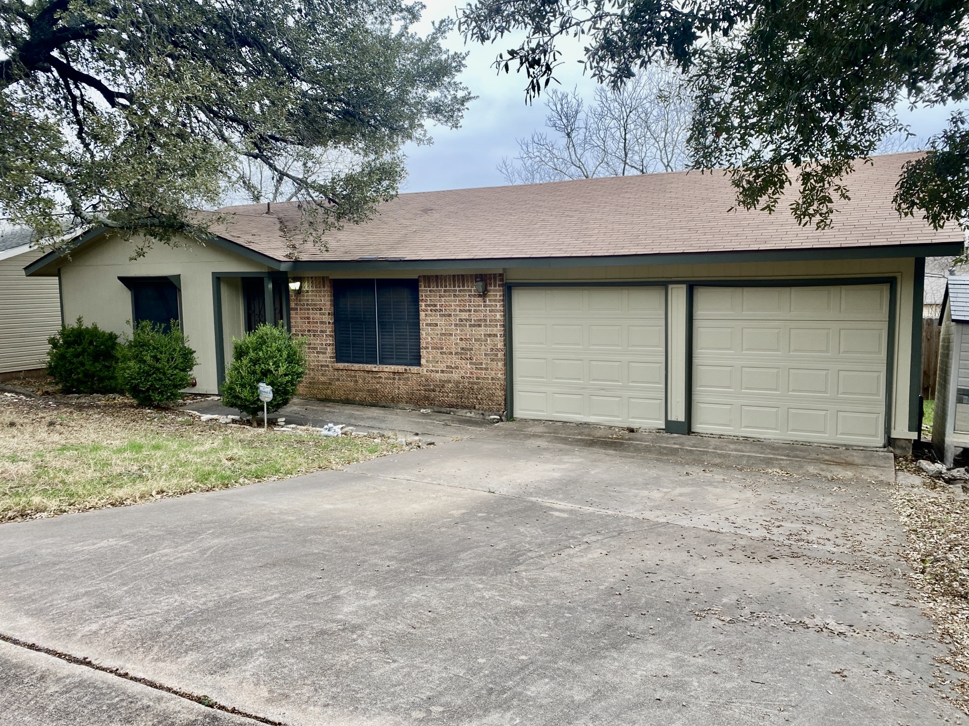 a front view of house with yard and trees around