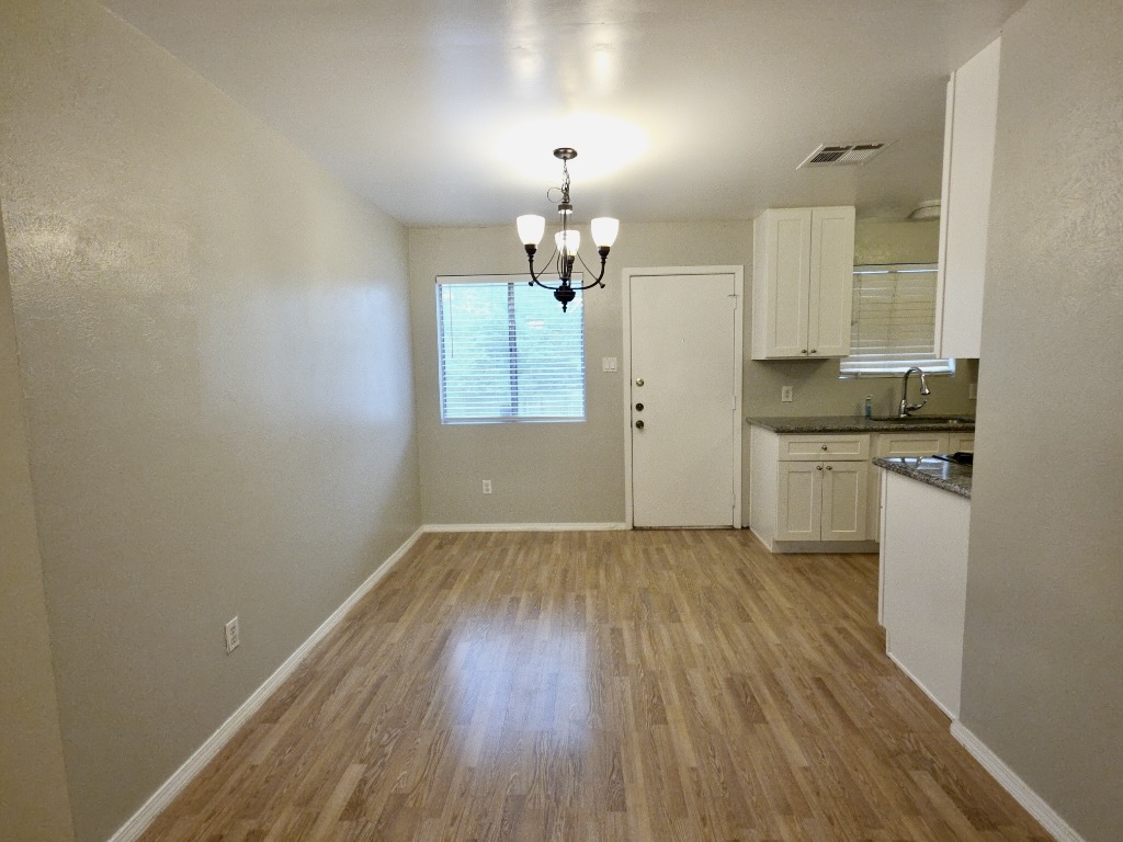 8508 Romney Road Austin, TX 78748 - Photo 4 of 21 wooden floor in an empty room with a window
