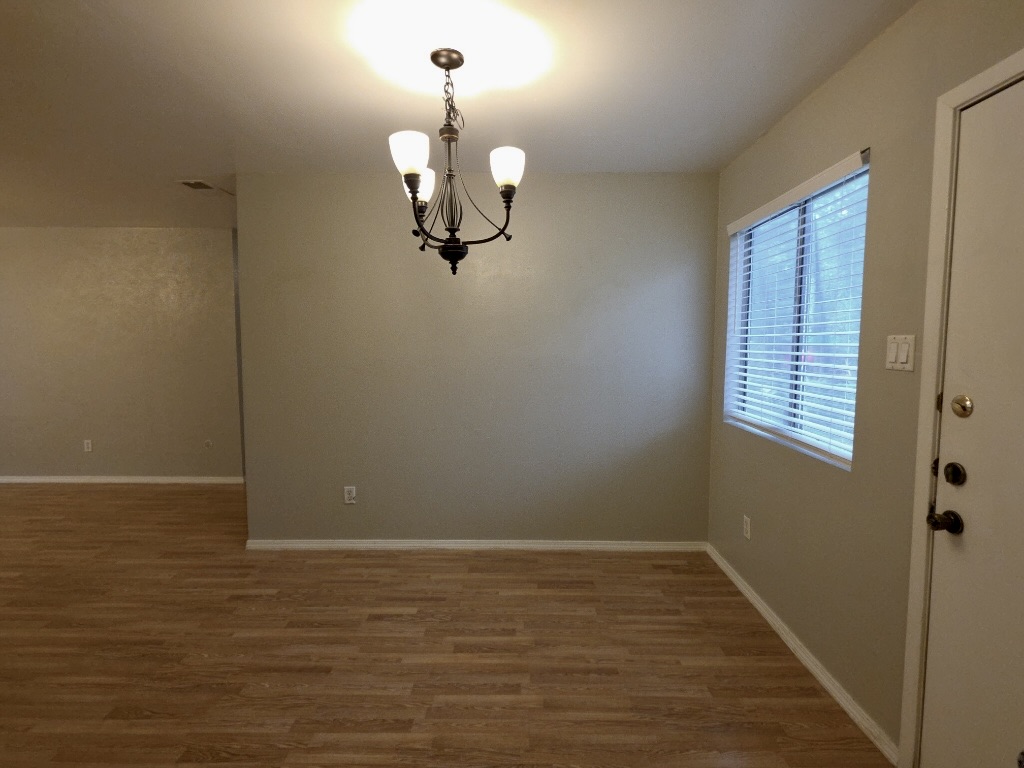 8508 Romney Road Austin, TX 78748 - Photo 5 of 21 a view of room with window and wooden floor
