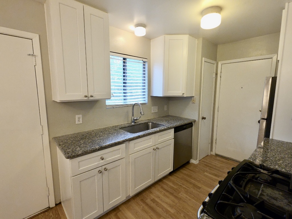 8508 Romney Road Austin, TX 78748 - Photo 8 of 21 a kitchen with a sink stove and cabinets