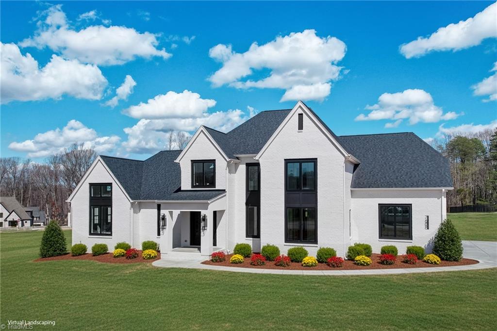 7688 Kyran Court Oak Ridge, NC 27310 - Photo 1 of 36 Front exterior ( landscaping is virtually added here). Home situated on nearly an acre lot on a cul de sac. *Actual landscaping will differ from photo.