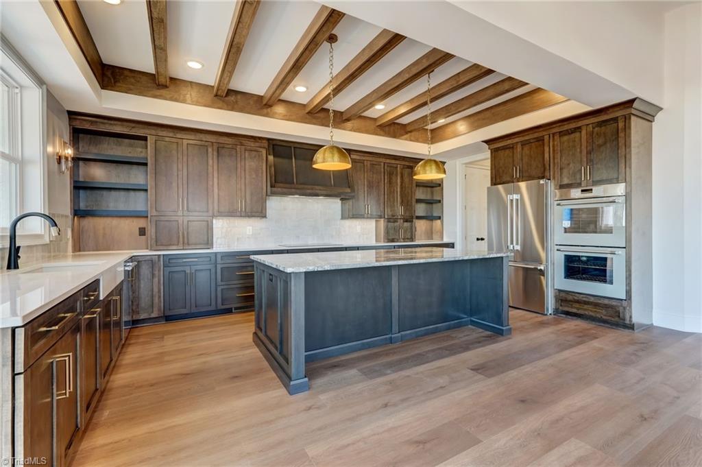 7688 Kyran Court Oak Ridge, NC 27310 - Photo 13 of 36 The ceiling is wood beam inset adding warmth and architectural interest