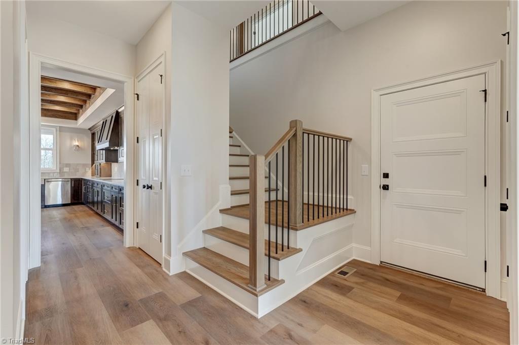 7688 Kyran Court Oak Ridge, NC 27310 - Photo 25 of 36 Staircase to second level off the garage entry