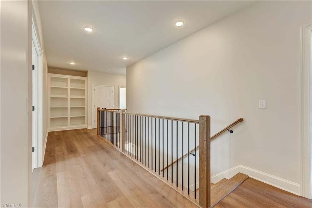 7688 Kyran Court Oak Ridge, NC 27310 - Photo 26 of 36 Upstairs landing features built-in shelving