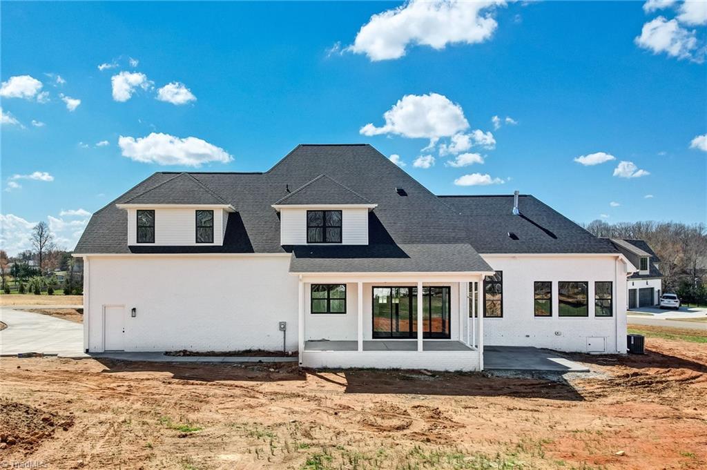 7688 Kyran Court Oak Ridge, NC 27310 - Photo 34 of 36 Back exterior of home, landscaping to be installed soon