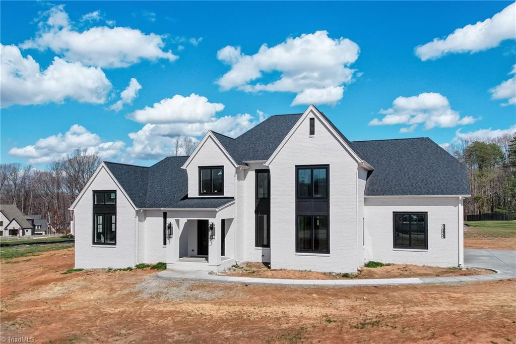 7688 Kyran Court Oak Ridge, NC 27310 - Photo 7 of 36 Current front exterior - landscaping will be installed in the coming weeks.