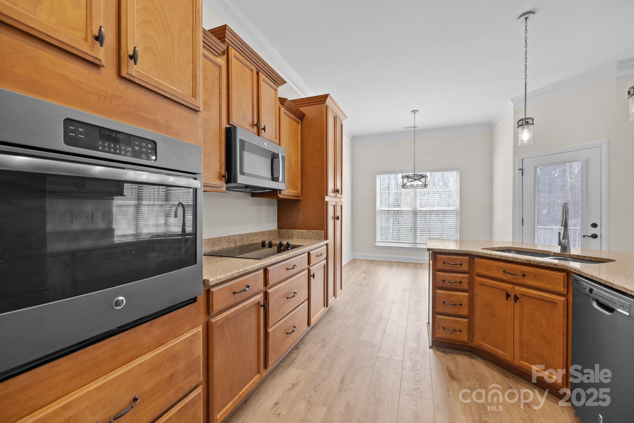 910 Pine Knoll Road, Unit 13 Fort Mill, SC 29715 - Photo 13 of 37 a large kitchen with stainless steel appliances wooden floor and a sink