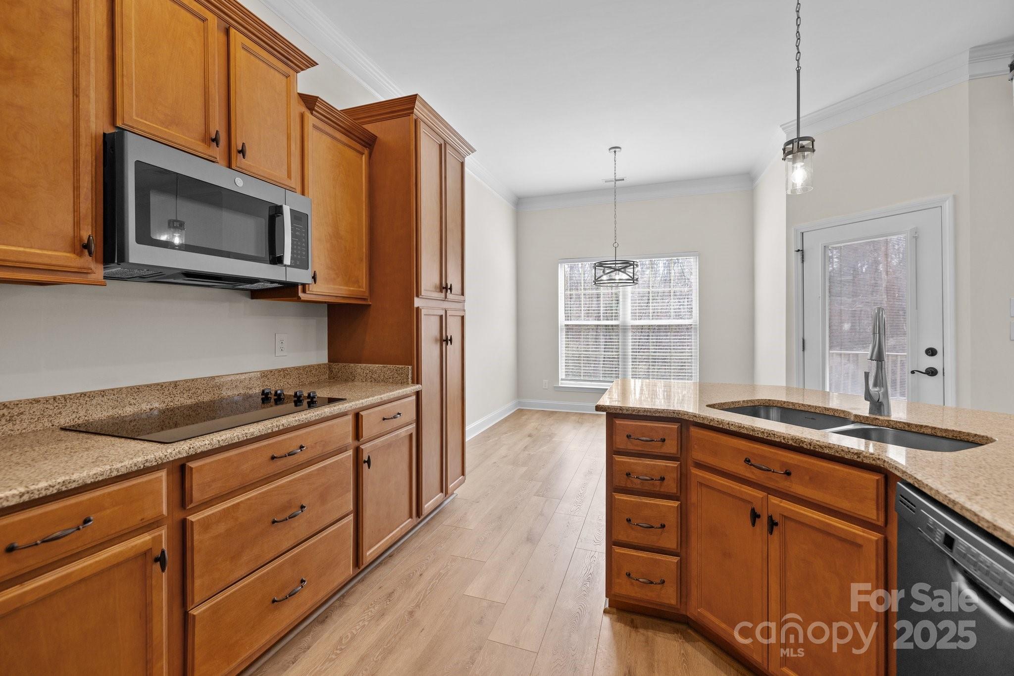 910 Pine Knoll Road, Unit 13 Fort Mill, SC 29715 - Photo 14 of 37 a kitchen with stainless steel appliances granite countertop a stove a sink and a microwave