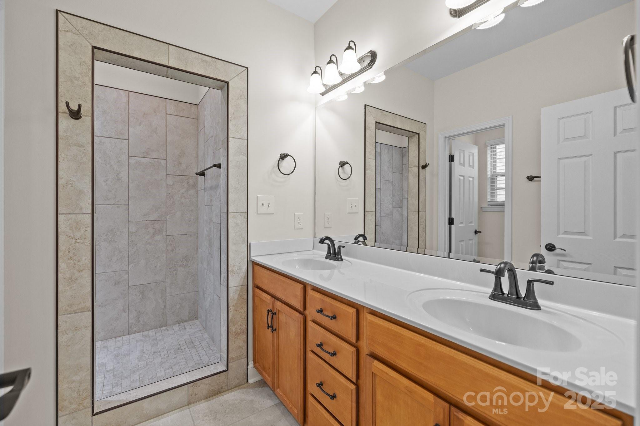 910 Pine Knoll Road, Unit 13 Fort Mill, SC 29715 - Photo 18 of 37 a bathroom with double vanity sinks and a shower