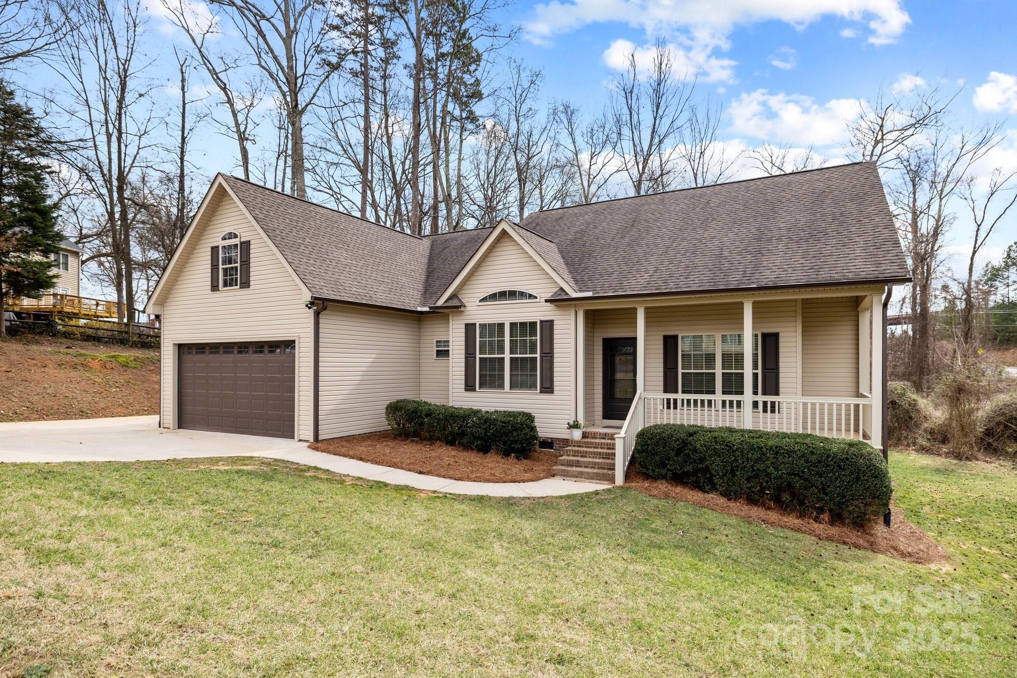 910 Pine Knoll Road, Unit 13 Fort Mill, SC 29715 - Photo 3 of 37 a front view of a house with a yard and garage