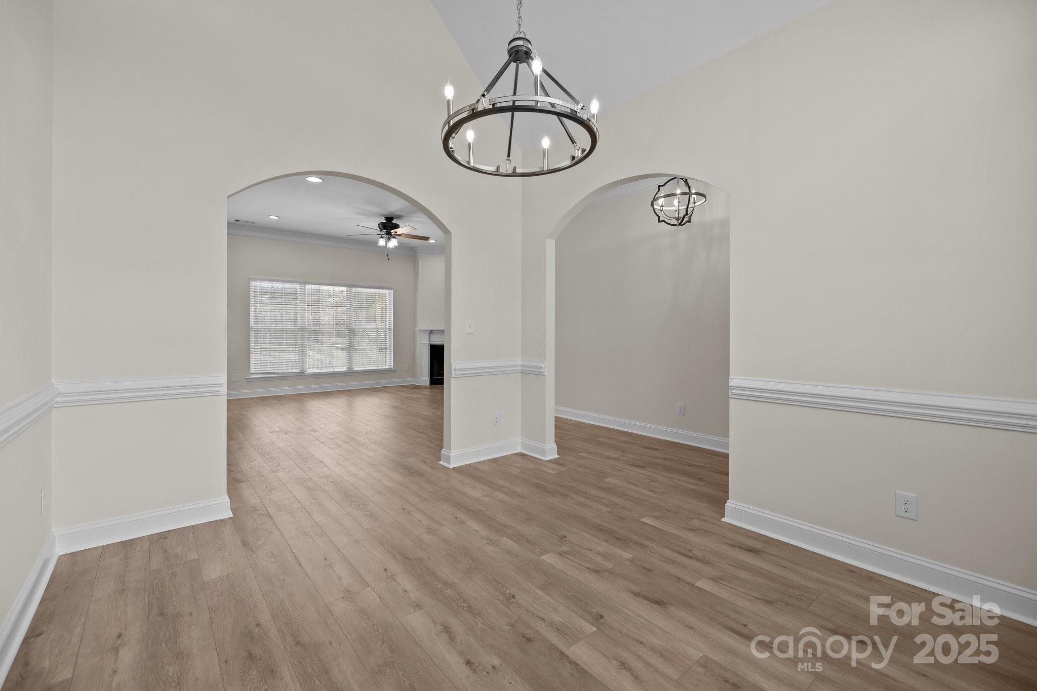 910 Pine Knoll Road, Unit 13 Fort Mill, SC 29715 - Photo 6 of 37 an empty room with wooden floor and mirror