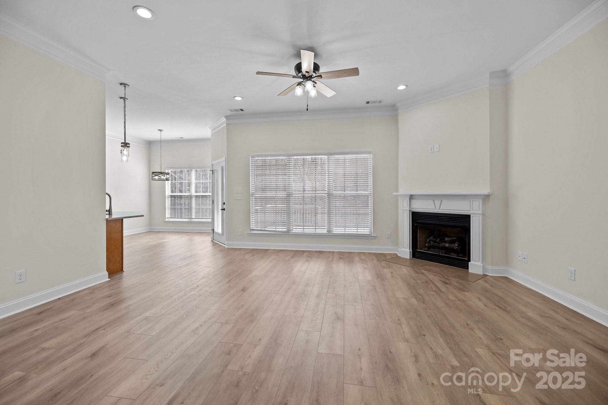 910 Pine Knoll Road, Unit 13 Fort Mill, SC 29715 - Photo 7 of 37 an empty room with wooden floor fireplace and windows